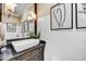 Chic powder room with a vessel sink, custom vanity, and stylish wall decor at 5670 W Linda Ln, Chandler, AZ 85226