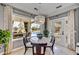 Cozy dining nook overlooking a pool, bathed in natural light and adorned with a decorative chandelier at 5670 W Linda Ln, Chandler, AZ 85226