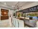 Elegant dining room with a large table, modern chandelier, and an open view to the pool, ideal for gatherings at 5670 W Linda Ln, Chandler, AZ 85226