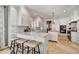 Bright kitchen featuring white cabinetry, marble countertops, a breakfast bar, and stainless steel appliances at 5670 W Linda Ln, Chandler, AZ 85226