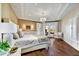 Luxurious main bedroom with tray ceiling, elegant chandelier, hardwood floors, and access to the patio at 5670 W Linda Ln, Chandler, AZ 85226