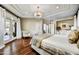 Bright main bedroom showcasing hardwood floors, patio access, and a stylish seating area with a chandelier at 5670 W Linda Ln, Chandler, AZ 85226