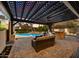 Inviting outdoor living space with a pergola, comfortable seating, outdoor kitchen and a sparkling pool at 5670 W Linda Ln, Chandler, AZ 85226