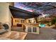 Outdoor kitchen with built-in grill and bar overlooking a lush backyard with a pool, ideal for entertaining guests at 5670 W Linda Ln, Chandler, AZ 85226
