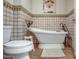 Bathroom features a classic white freestanding tub, adjacent to the toilet at 5801 N 25Th Pl, Phoenix, AZ 85016