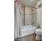 Bathroom with white tile shower and tub combination, and a standard height toilet at 5801 N 25Th Pl, Phoenix, AZ 85016
