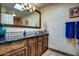 Bathroom featuring granite countertop, dark wood cabinets, and a decorative blue vase at 5801 N 25Th Pl, Phoenix, AZ 85016