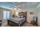 Bedroom with a ceiling fan, shuttered window, and rustic wood bed frame at 5801 N 25Th Pl, Phoenix, AZ 85016