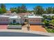 Inviting front exterior featuring a private entry and two-car garage, showcasing a charming desert home at 5801 N 25Th Pl, Phoenix, AZ 85016
