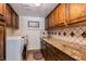 Convenient laundry room with modern washer and dryer, granite countertop, and ample storage at 5801 N 25Th Pl, Phoenix, AZ 85016