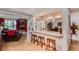 Inviting living space with a granite breakfast bar, fireplace, and seamless flow to the kitchen and dining area at 5801 N 25Th Pl, Phoenix, AZ 85016