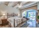 Spacious main bedroom featuring a beamed ceiling, sitting area, and wrought iron bed frame at 5801 N 25Th Pl, Phoenix, AZ 85016