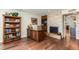 An office features a stone fireplace, wood floors, a wood desk, and a bookshelf at 5801 N 25Th Pl, Phoenix, AZ 85016