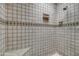 White tile shower with a built-in bench and niche for toiletries at 5801 N 25Th Pl, Phoenix, AZ 85016