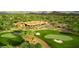 An aerial view shows a clubhouse on a golf course with desert landscape at 6181 E Brilliant Sky Dr, Scottsdale, AZ 85266