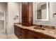 Bathroom with granite counters, dual sinks, and decorative lighting at 6181 E Brilliant Sky Dr, Scottsdale, AZ 85266