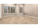 Bright bedroom with tile floors, neutral walls, and plantation shutters at 6181 E Brilliant Sky Dr, Scottsdale, AZ 85266