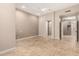 Spacious bedroom with tile floors and open doorway to bathroom at 6181 E Brilliant Sky Dr, Scottsdale, AZ 85266