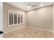 Bright bedroom with tile floors, neutral walls, and plantation shutters at 6181 E Brilliant Sky Dr, Scottsdale, AZ 85266