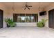 Spacious covered patio with elegant stone flooring, offering a seamless transition to outdoor living and backyard views at 6181 E Brilliant Sky Dr, Scottsdale, AZ 85266