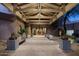 Inviting entryway with wooden beams, potted plants, and concrete benches for a serene arrival experience at 6181 E Brilliant Sky Dr, Scottsdale, AZ 85266