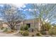 Desert-landscaped home with barrel cactus and trees beneath a blue sky at 6181 E Brilliant Sky Dr, Scottsdale, AZ 85266