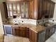 Spacious wet bar featuring granite counters, custom cabinets, and a wine fridge at 6181 E Brilliant Sky Dr, Scottsdale, AZ 85266