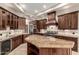 Gourmet kitchen with granite countertops, custom cabinetry and stainless steel appliances at 6181 E Brilliant Sky Dr, Scottsdale, AZ 85266