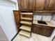 Pantry featuring pull-out shelves and custom wood cabinetry at 6181 E Brilliant Sky Dr, Scottsdale, AZ 85266