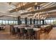 Restaurant dining area with stone bar, counter seating, neutral chairs, and views at 6181 E Brilliant Sky Dr, Scottsdale, AZ 85266