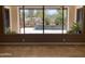 View from inside the house of a pool and landscaped backyard with desert plants at 6181 E Brilliant Sky Dr, Scottsdale, AZ 85266
