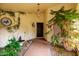 Inviting front entryway with decorative plants, a water feature, and stained glass accents at 655 W Port Au Prince W Ln, Phoenix, AZ 85023