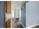 Hallway with wood style floors, utility closet, and light blue accent wall at 6938 E Flossmoor Ave, Mesa, AZ 85208