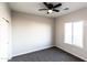 Comfortable bedroom featuring neutral carpet, a ceiling fan and a bright window with lots of natural light at 8315 W Concordia Dr, Arizona City, AZ 85123