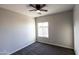 Comfortable bedroom featuring neutral carpet, a ceiling fan and a bright window with lots of natural light at 8315 W Concordia Dr, Arizona City, AZ 85123