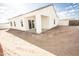 Rear exterior view showcasing backyard patio area with sliding glass doors at 8315 W Concordia Dr, Arizona City, AZ 85123