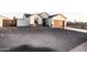 Inviting single-Gathering home featuring a xeriscaped yard and a long concrete driveway leading to the attached garage at 8315 W Concordia Dr, Arizona City, AZ 85123