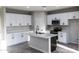 Bright kitchen boasts white shaker cabinets, modern appliances, ample counter space and an island with bar seating at 8315 W Concordia Dr, Arizona City, AZ 85123