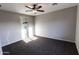Neutral-toned primary bedroom with carpet, ceiling fan, ensuite bathroom and a shower with glass doors at 8315 W Concordia Dr, Arizona City, AZ 85123