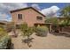 Exterior view of a home featuring desert landscaping, a covered patio and a built-in fire pit at 8339 W Molly Ln, Peoria, AZ 85383