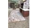 Desert landscaped backyard featuring built-in BBQ and circular fire pit on a decorative brick surface at 8339 W Molly Ln, Peoria, AZ 85383