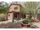 A spacious backyard featuring a paved patio, a built-in fire pit, and a well-maintained artificial grass area at 8339 W Molly Ln, Peoria, AZ 85383