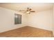 Bedroom featuring wood-look floors, neutral color palette, and standard window at 8339 W Molly Ln, Peoria, AZ 85383