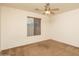 Carpeted bedroom featuring a standard window and neutral color palette at 8339 W Molly Ln, Peoria, AZ 85383