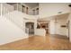 Bright living room featuring a staircase, high ceilings, hardwood floors, and access to the kitchen at 8339 W Molly Ln, Peoria, AZ 85383