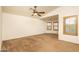Bright primary bedroom features neutral carpet, ceiling fan, and shuttered windows at 8339 W Molly Ln, Peoria, AZ 85383