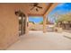 Covered back patio features ceiling fan and built-in barbecue with nice garden views at 8367 W Lariat Ln, Peoria, AZ 85383