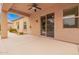 Covered back patio features ceiling fan, sliding door, and garden views at 8367 W Lariat Ln, Peoria, AZ 85383