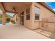 This large covered patio features an outdoor kitchen and seating with view of the beautiful swimming pool at 8367 W Lariat Ln, Peoria, AZ 85383