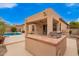 Inviting backyard featuring a built-in grill, covered patio, and refreshing pool perfect for outdoor entertaining at 8367 W Lariat Ln, Peoria, AZ 85383